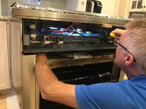 A technician diagnosing and repairing common stove problems in Charleston, SC.