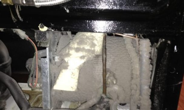 A dirty oven and door in a Charleston kitchen, showcasing the necessity of preventative maintenance for a clean and efficient cooking space.