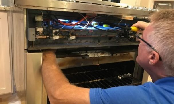 A technician diagnosing and repairing common stove problems in Charleston, SC.