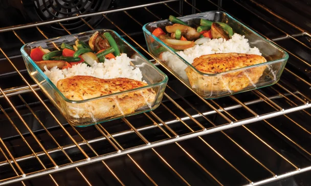 Two glass containers filled with food placed on an oven rack in a Charleston kitchen, highlighting the issue of the GE oven not heating properly.