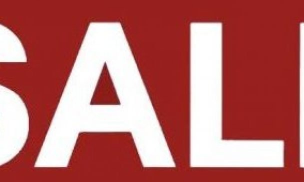 An eye catching sale sign with 'SALE' in white, advertising Black Friday appliance deals in Charleston.